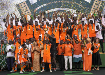 Ivory Coast 's Max-Alain Gradel lifts the trophy after winning the African Cup of Nations final soccer match between Nigeria and Ivory Coast, at the Olympic Stadium of Ebimpe in Abidjan, Ivory Coast, Sunday, Feb. 11, 2024. (AP Photo/Sunday Alamba)